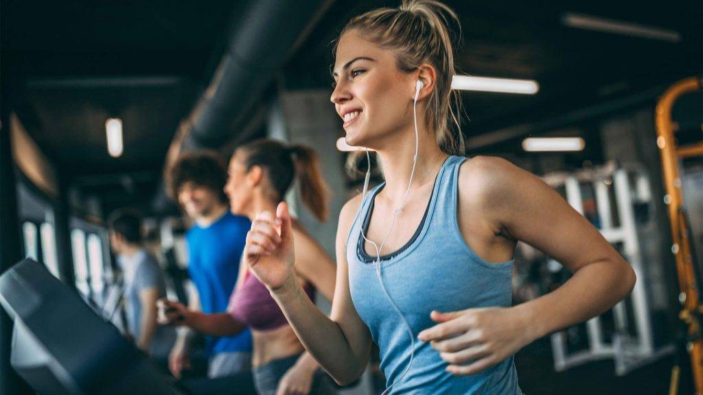 People exercising on treadmills at Spectrum Resort Orlando fitness center.