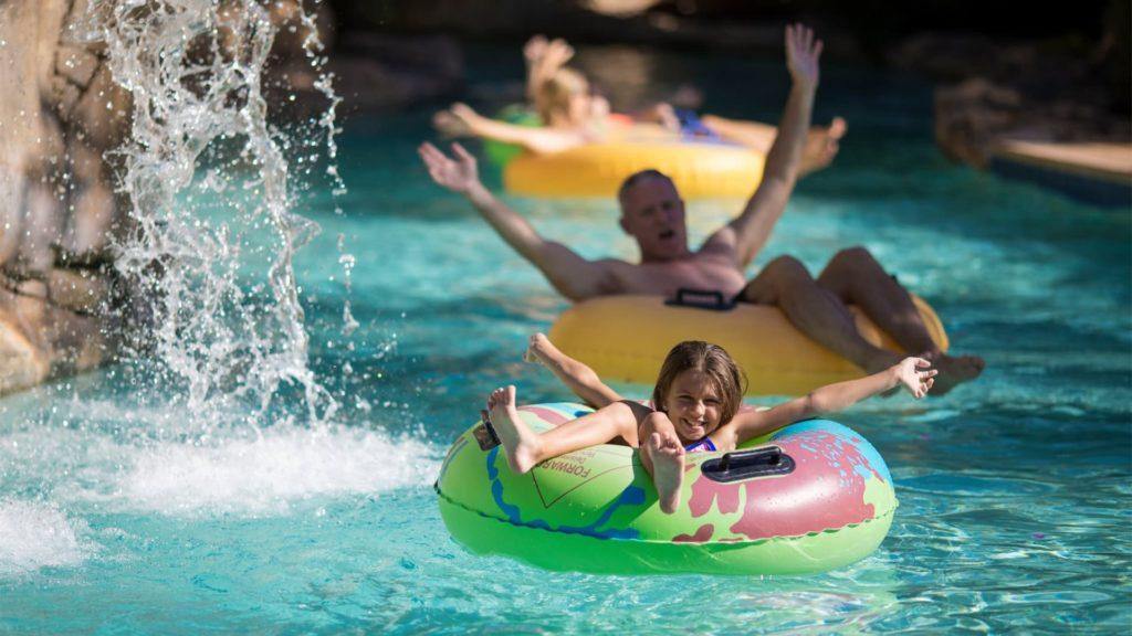 Familia flotando en el río lento en el parque acuático en Spectrum Resort Orlando.