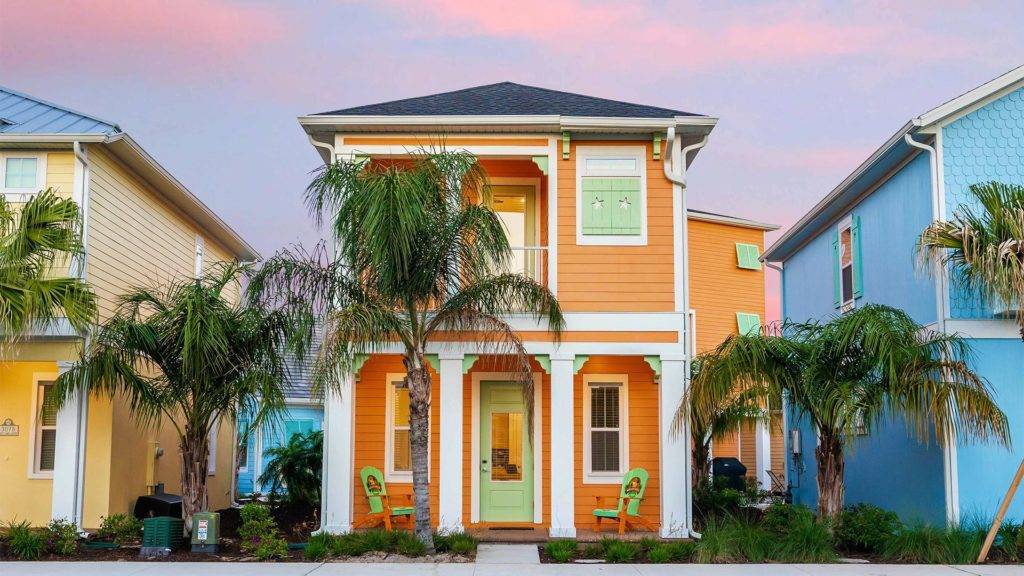 Front of a 2-story cottage painted orange at Margaritaville Resort Orlando.