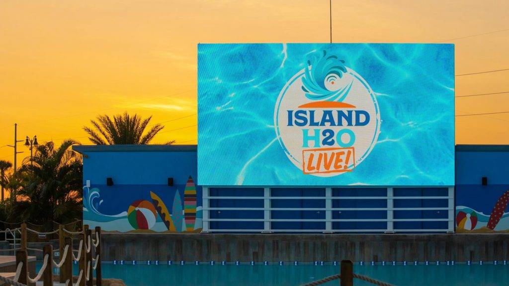 The big screen at the Island H2O Live! Lagoon wave pool at sunset.