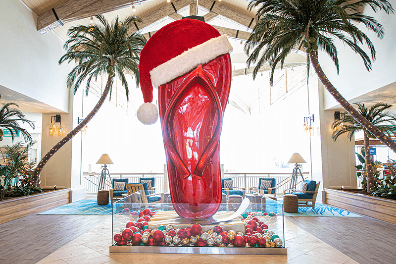 Giant flip flop sculpture topped with a Santa Claus hat in the Margaritaville Resort Orlando hotel lobby.