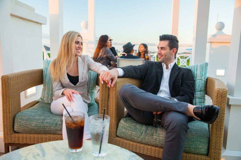 Couple holding hands while sitting on the Encore Resort at Reunion Third Floor Terrace.