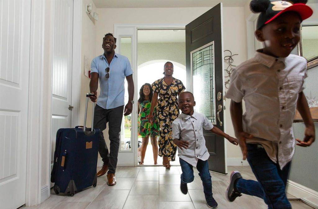 Children run into their Encore Resort vacation home rental as their family arrives.