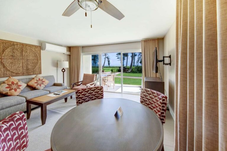 Living room with dining room table at Pono Kai Resort
