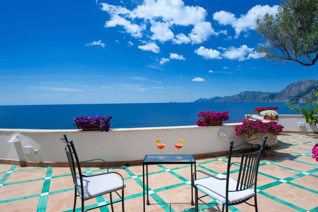 Villa Lilly outdoor terrace with dining table overlooking the water.
