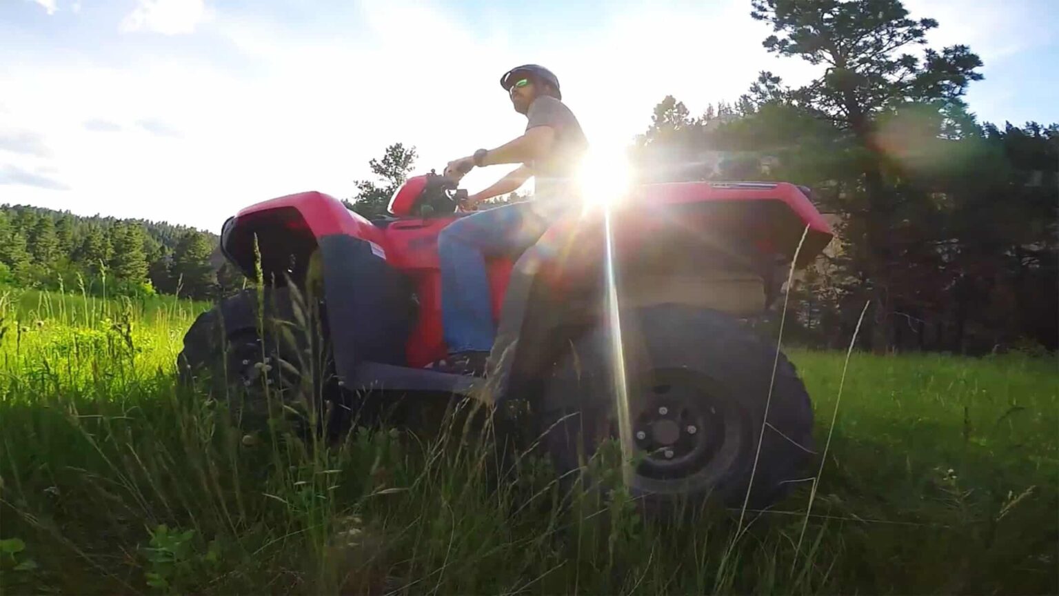 Man riding an ATV at sunset at The Ranches at Belt Creek.