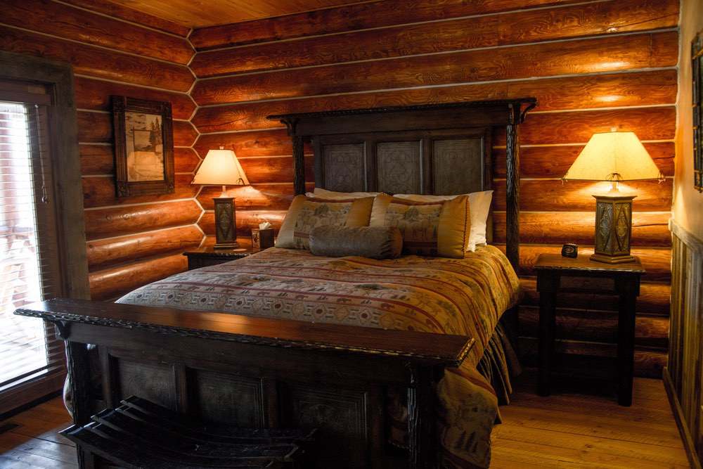 Lazy Doe Ranch rustic log cabin style master bedroom.