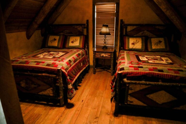 Rustic double bedroom at The Ranches at Belt Creek member cabins.