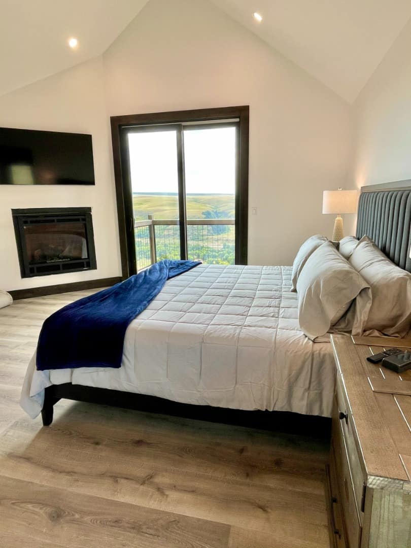Sunset Ranch bedroom with fireplace and outdoor porch access