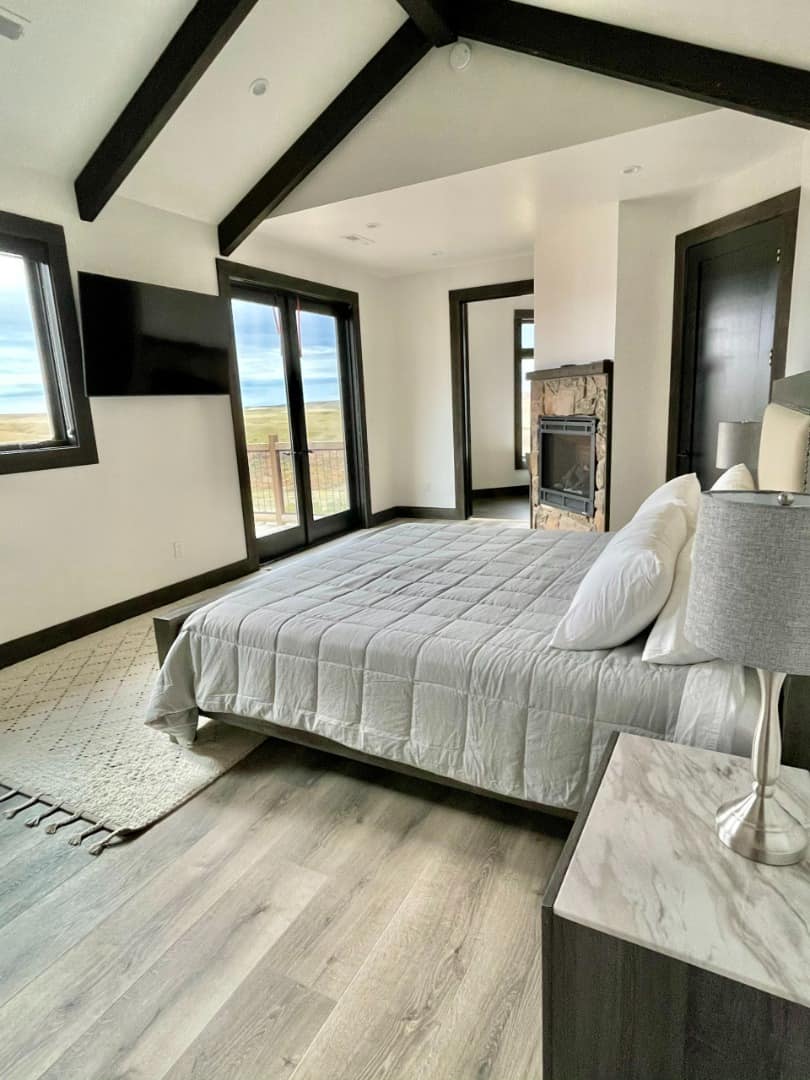 Sunset Ranch bedroom with wall mounted TV and outdoor porch access