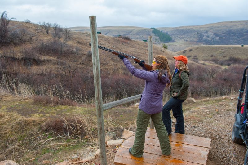 Women shooting sporting clays in winter at The Ranches at Belt Creek.