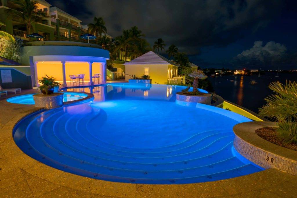 Infinity pool at night in Bermuda at Newstead Belmont Hills Golf Resort and Spa.