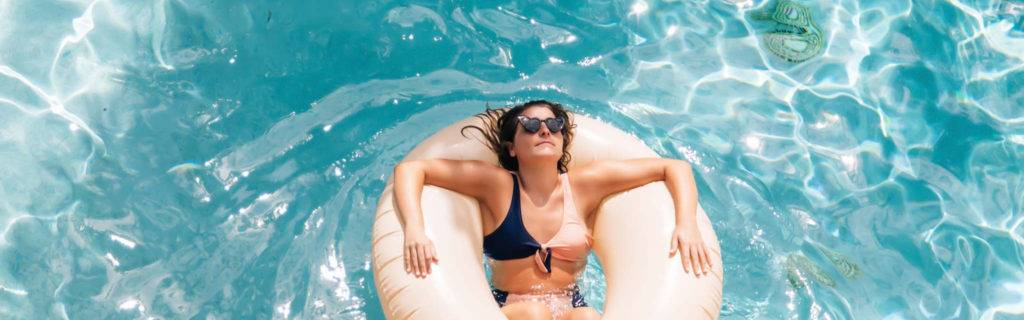Woman relaxing in a pool float.
