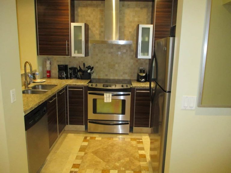 Full kitchen with oven range, refrigerator, and sink: Premium 1 Bedroom Suite at The Atrium Resort