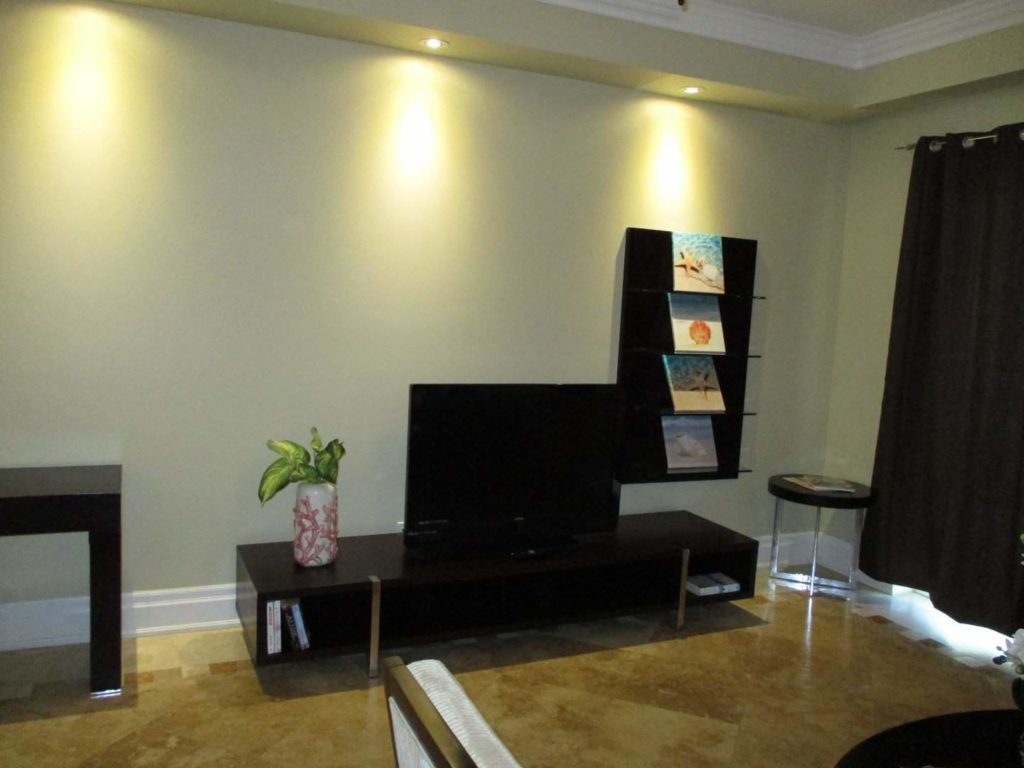 Living room with flat-screen TV: Premium 1 Bedroom Suite at The Atrium Resort