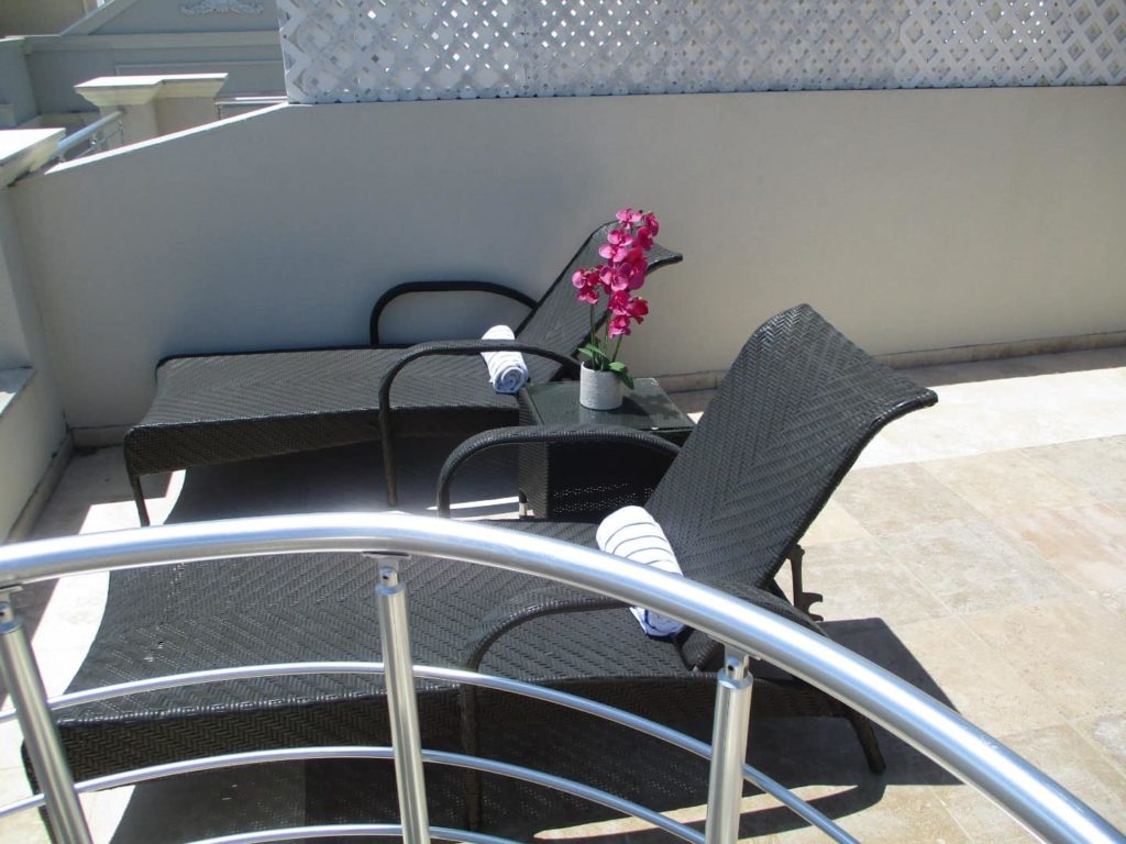 Outdoor balcony with lounge chairs: 3 Bedroom Penthouse at The Atrium Resort