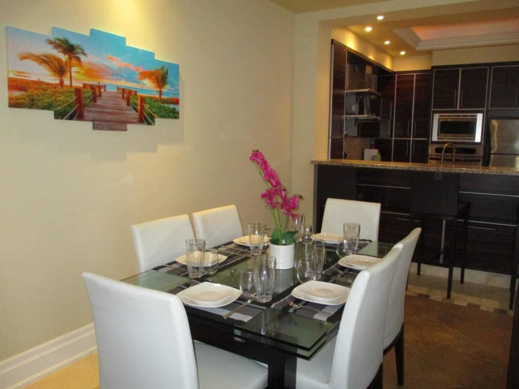 Dining room and kitchen with island seating: 4 Bedroom Penthouse at The Atrium Resort