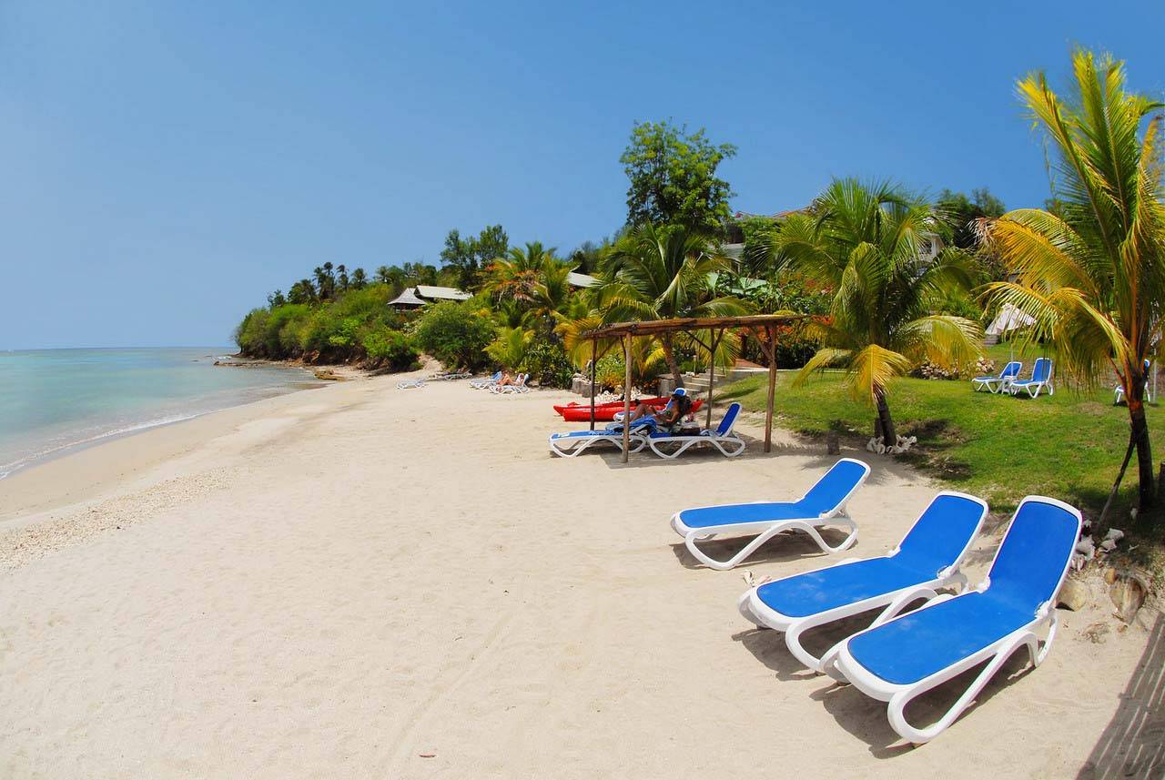 Lounge chairs on Calabash Cove’s sheltered beach in Saint Lucia.