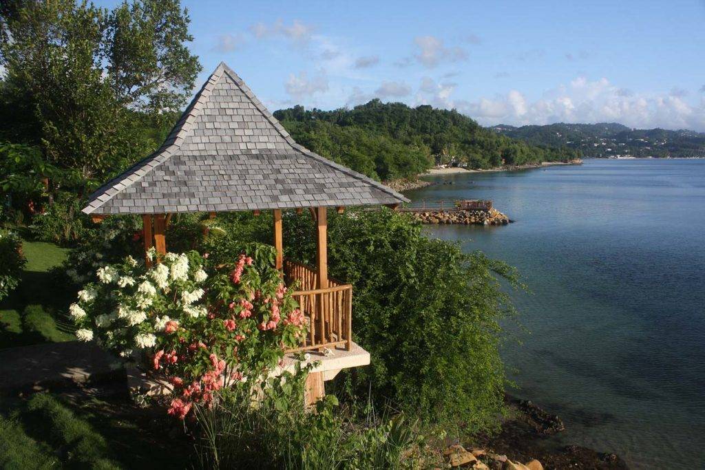 Wedding gazebo at Calabash Cove surrounded by flowers and overlooking the resort’s secluded beach.