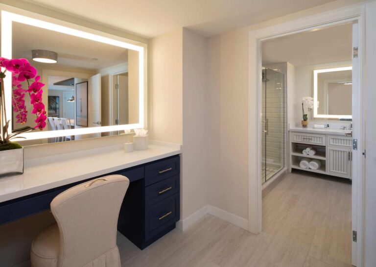 Suite bathroom with backlit vanity mirror