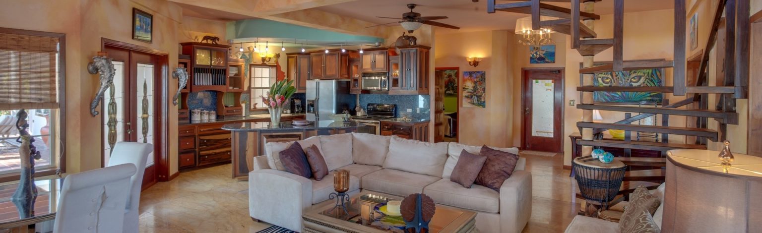 Spacious, modern villa living room, dining room, and kitchen at Chabil Mar Villas.