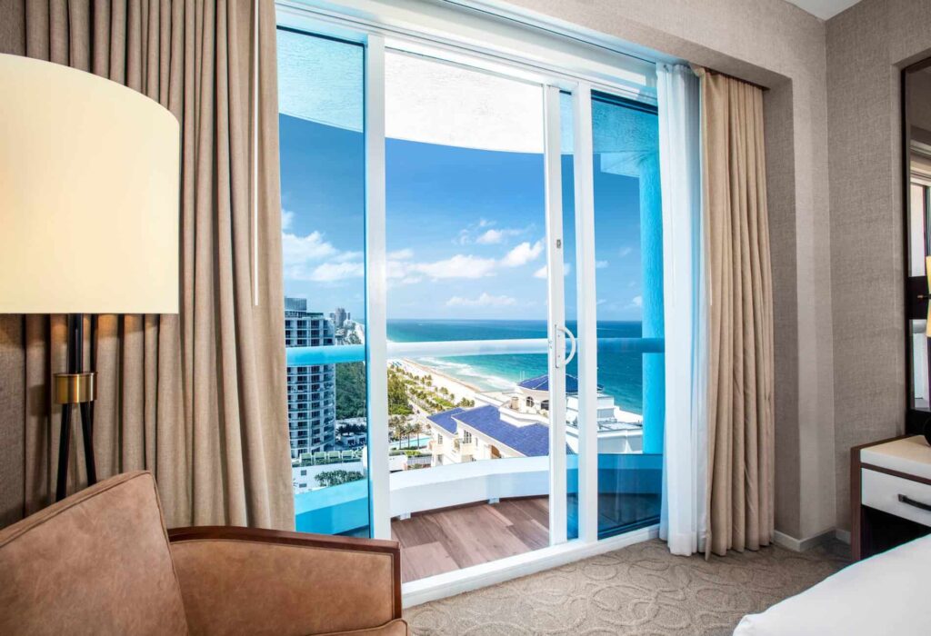 One Bedroom Suite balcony with partial ocean view.