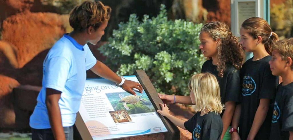 Animal behaviorist at Atlantis Paradise Island teaching a group of kids