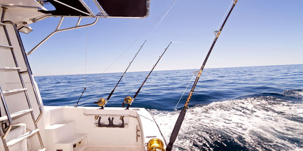 Fishing rods off a boat on the ocean.