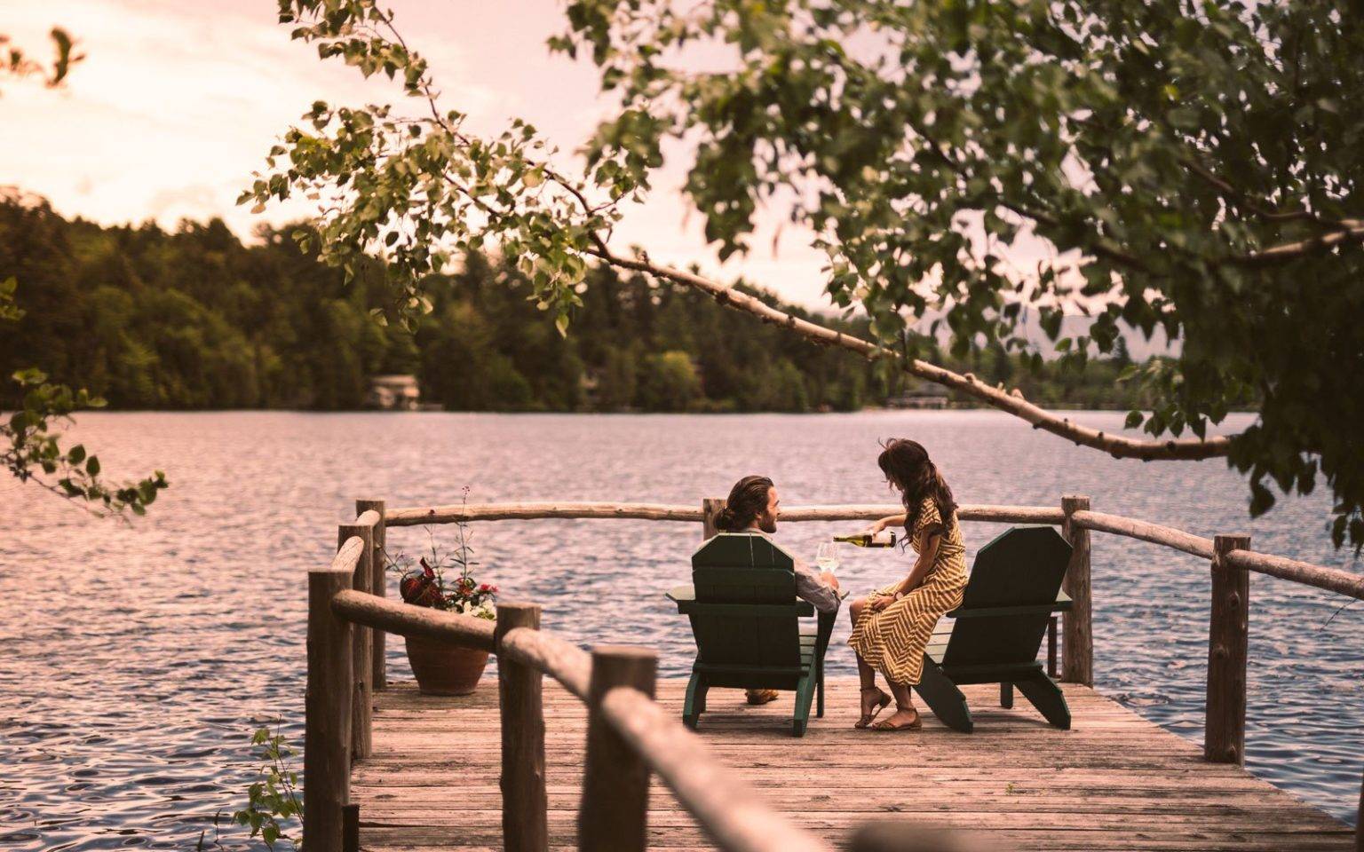 Couple sharing a glass a wine on the dock on Mirror Lake.