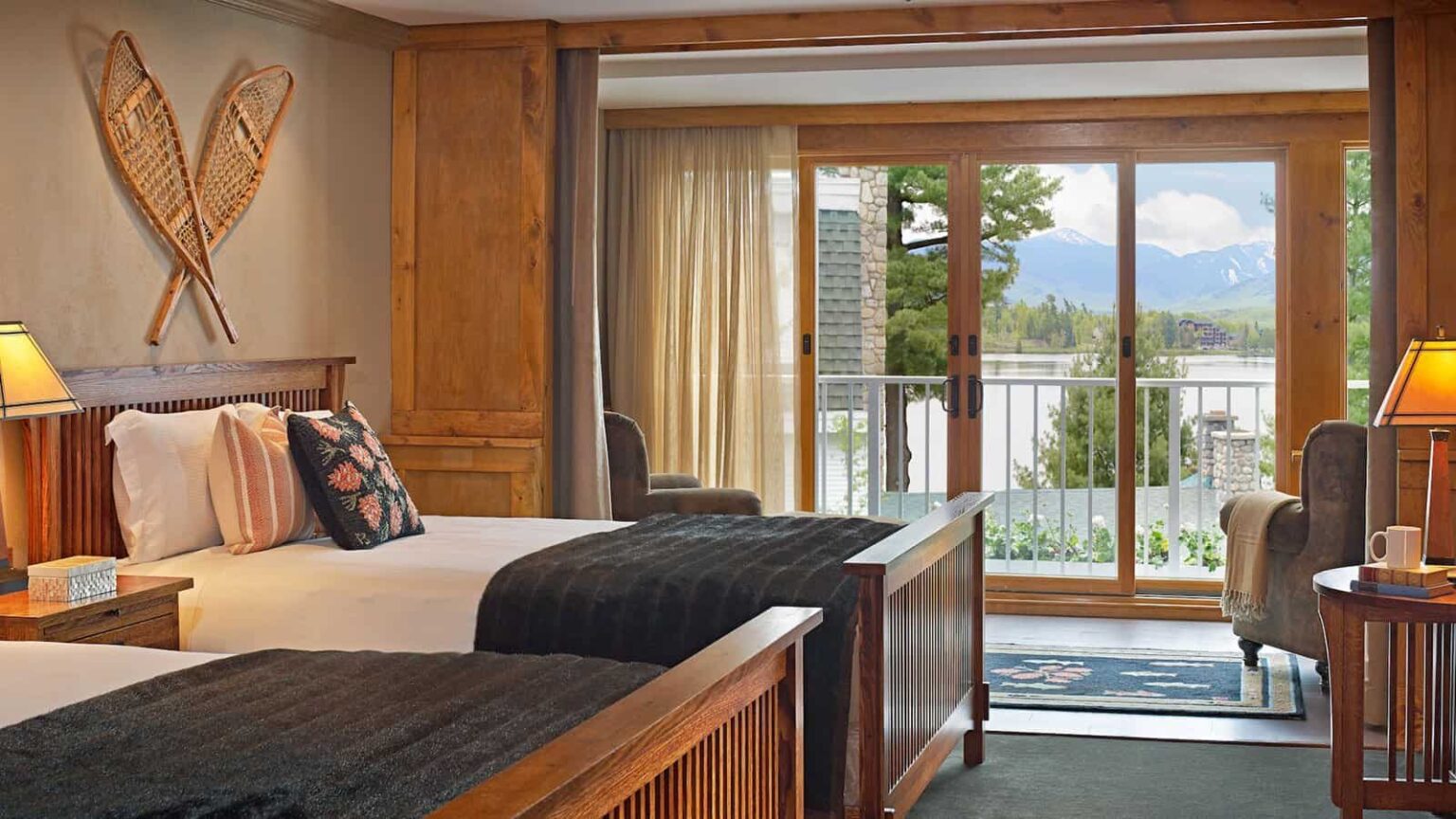 Mirror Lake Inn room with two queen beds and sunroom sitting area