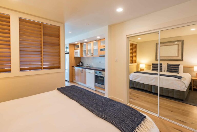 Superior-Suite mit Kingsize-Bett und seitlichem Blick auf die Küchenzeile und Trennwand zum Essbereich