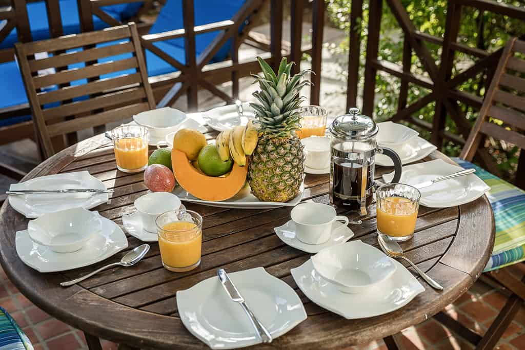 Outdoor terrace with dining room set for breakfast: Cap Cove 2 Bedroom Suite