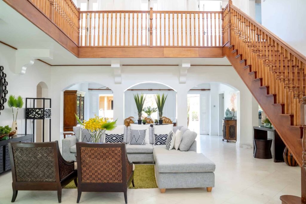 Spacious living room with staircase to upper floor: Cap Cove 4 Bedroom Villa