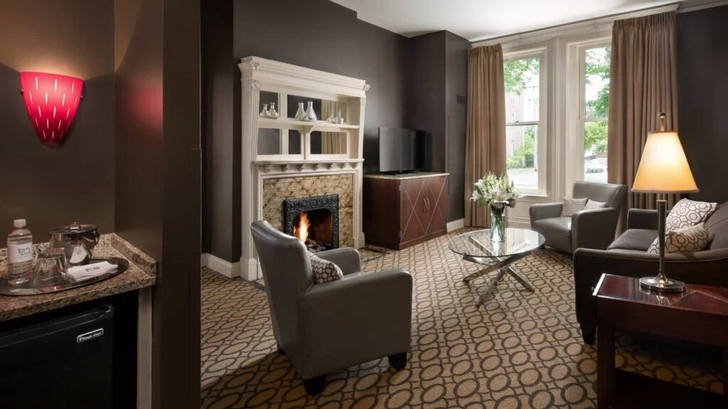 Deluxe suite seating area with fireplace at The Mansion on Delaware Avenue.