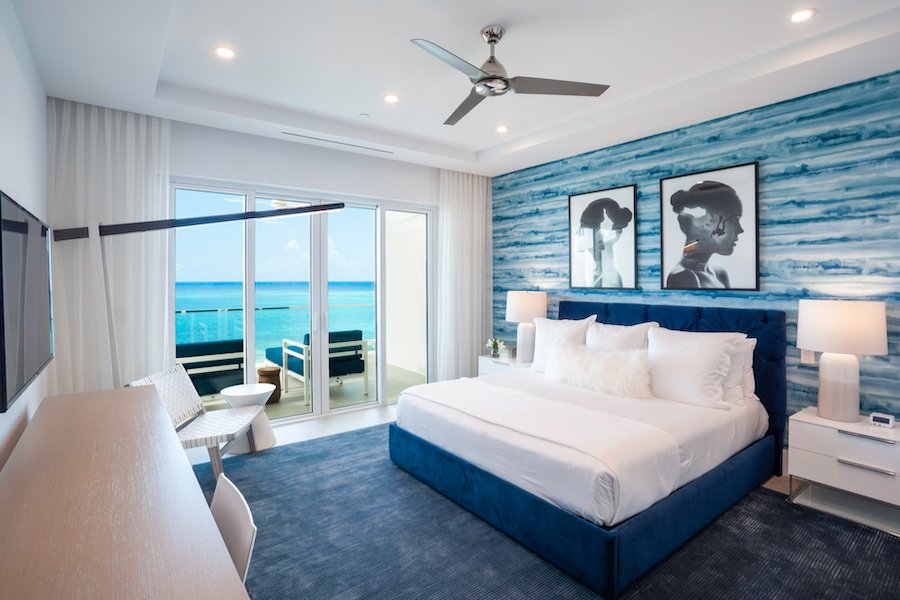 King bedroom with oceanfront balcony access: Rum Point Club One Bedroom Family Residence
