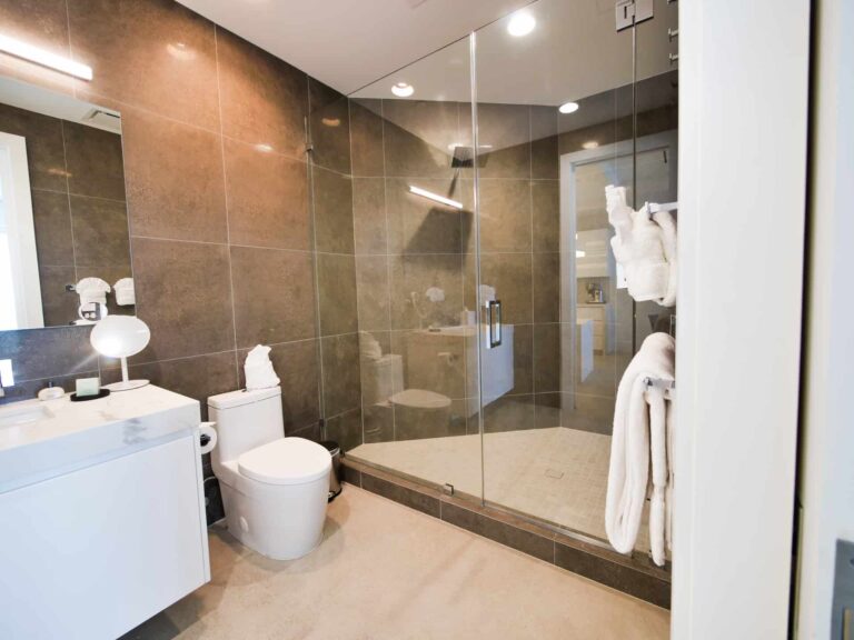 Bathroom with glass door standing shower: Rum Point Club 1 Bedroom Residence