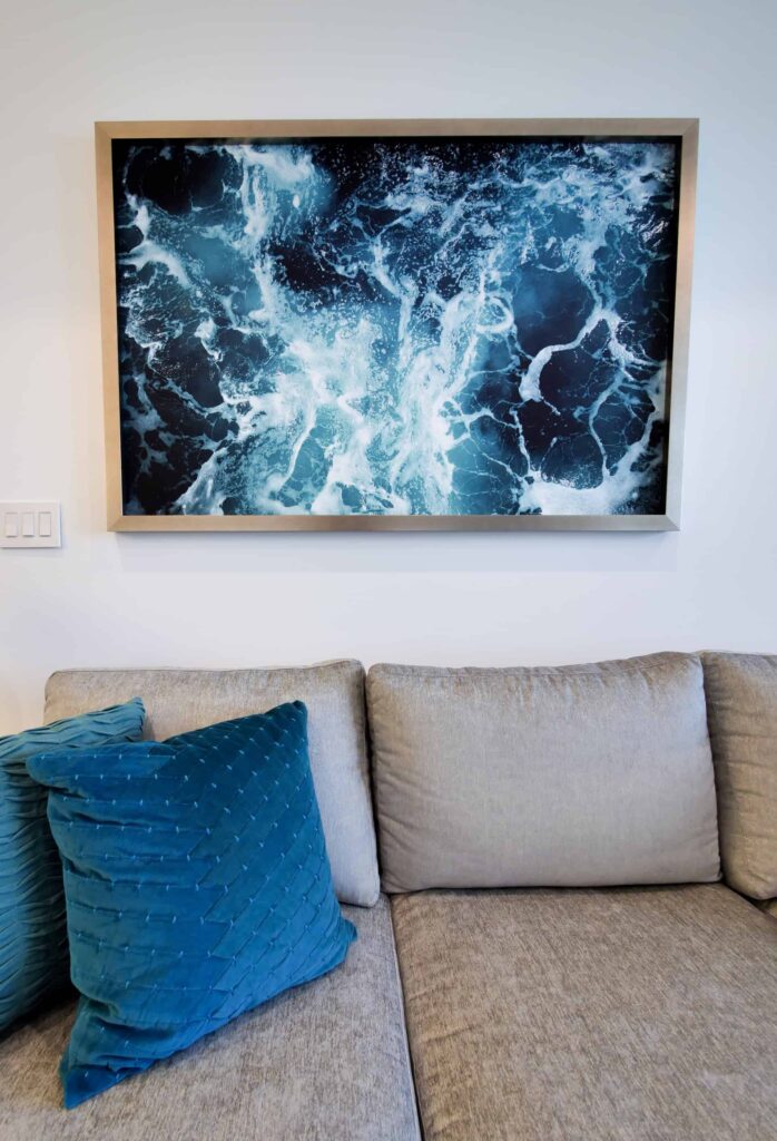 Living room with ocean-inspired wall art: Rum Point Club 1 Bedroom Residence