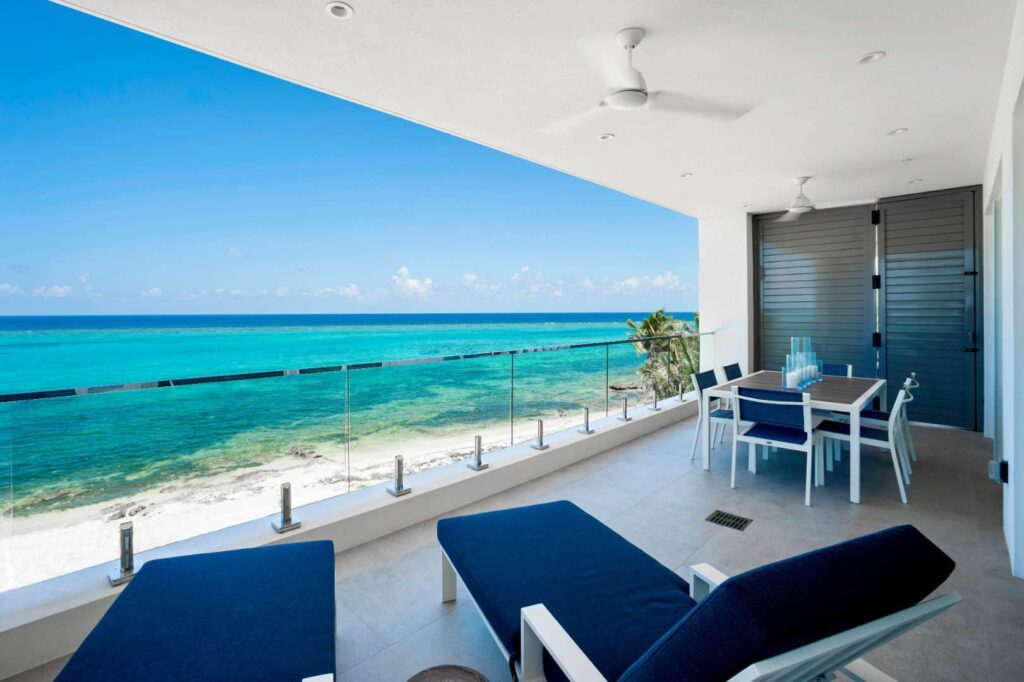 Covered outdoor balcony with ocean view: 2 Bedroom Family Residence at Rum Point Club