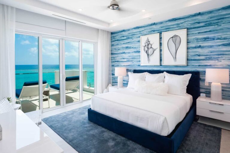 Bedroom with oceanfront balcony access: 2 Bedroom Family Residence at Rum Point Club