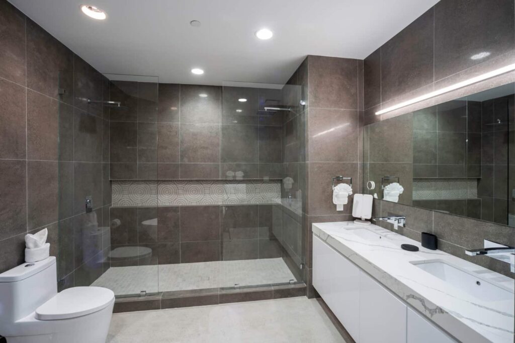 Spacious bathroom with glass door shower stall: Rum Point Club 2 Bedroom Residence