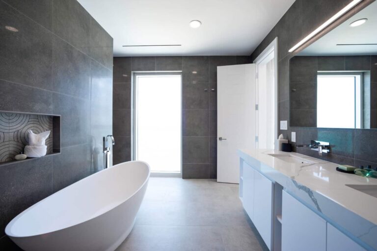 Spacious master bathroom with freestanding tub: Penthouse at Rum Point Club