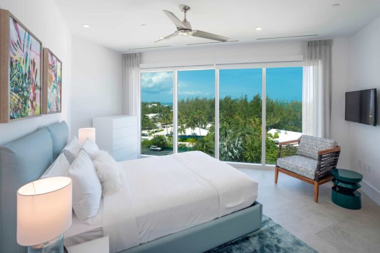 Queen bedroom suite with large windows: 4 Bedroom Penthouse at Rum Point Club