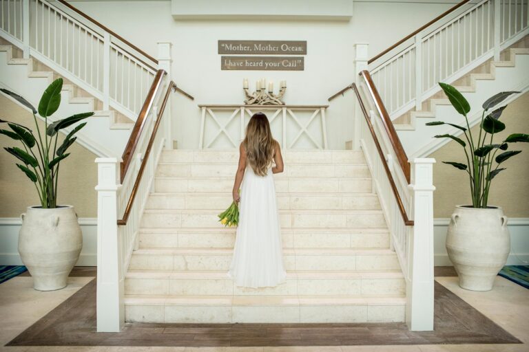Bride in wedding dress posing on the stairs at Margaritaville Resort Orlando.