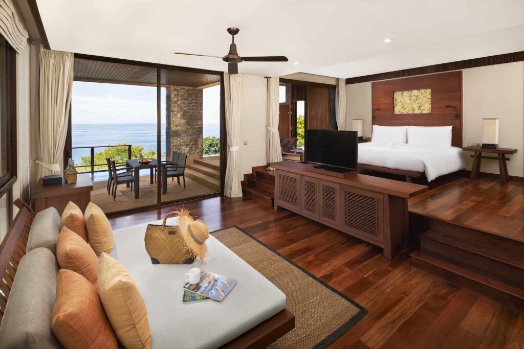 2 Bedroom Ocean Pool Suite master bedroom with sofa bed and access to outdoor living area