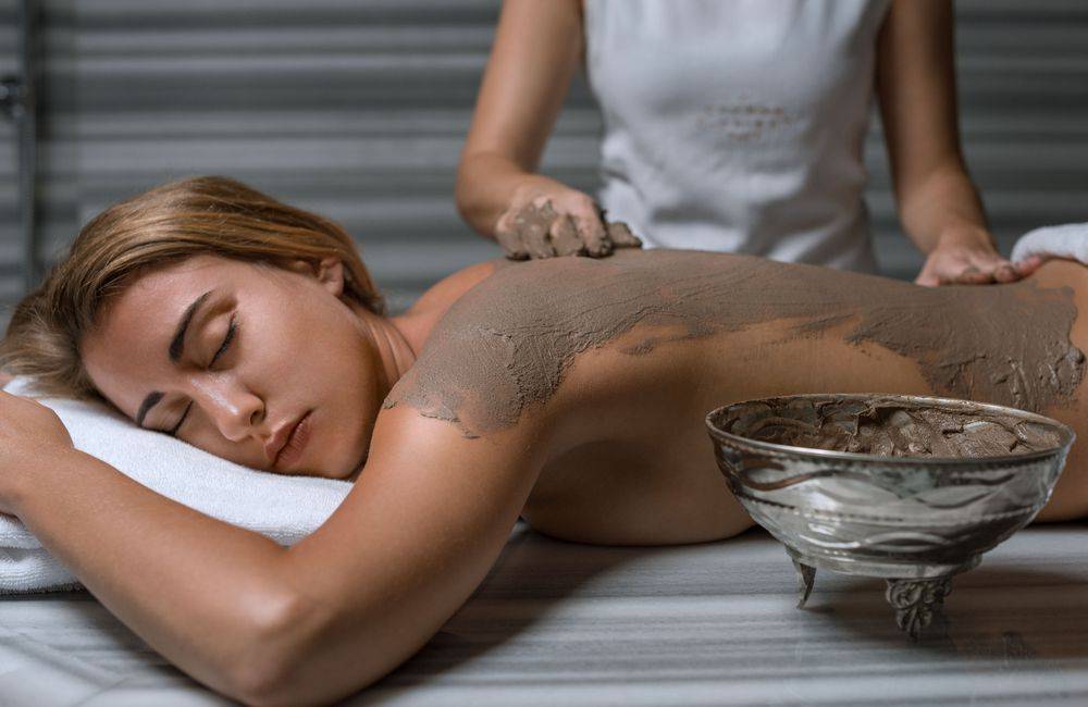 Woman receiving at body treatment at Pine Cliffs Resort Spa