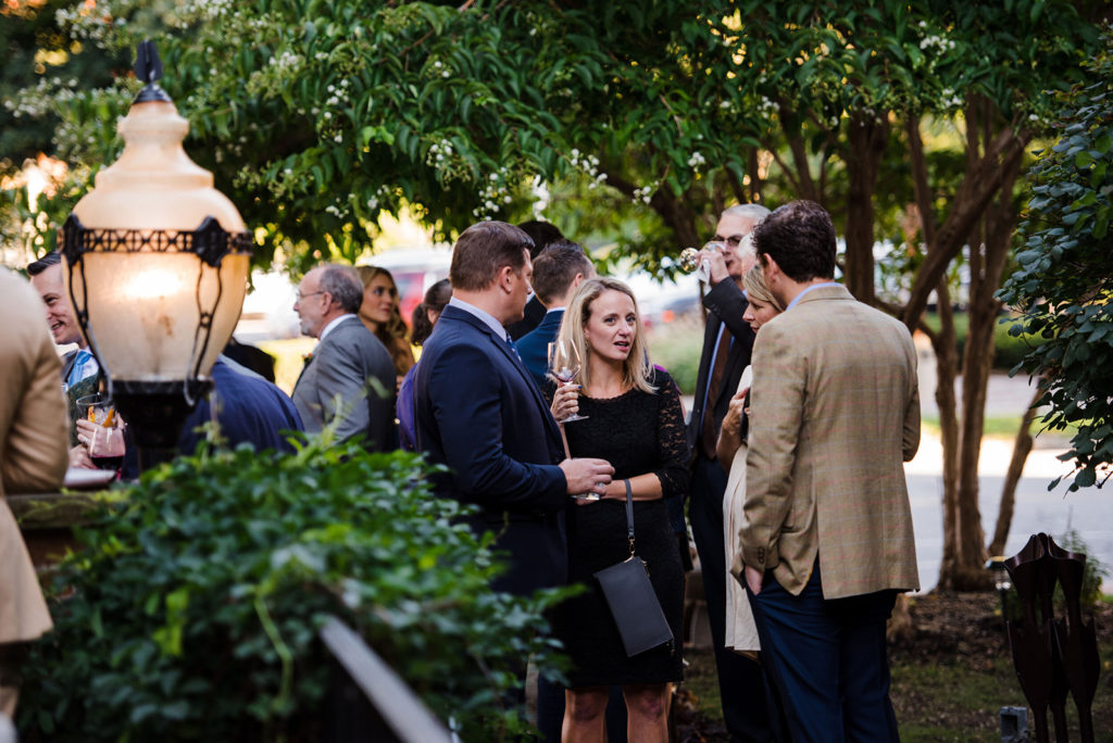 Group of people chatting at an outdoor business event.