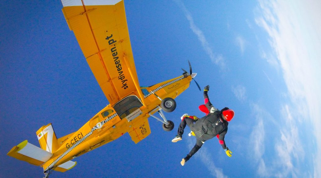 Skydiving out of a plane in the air