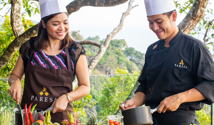 Guest participating in a private cooking class at Paresa Resort