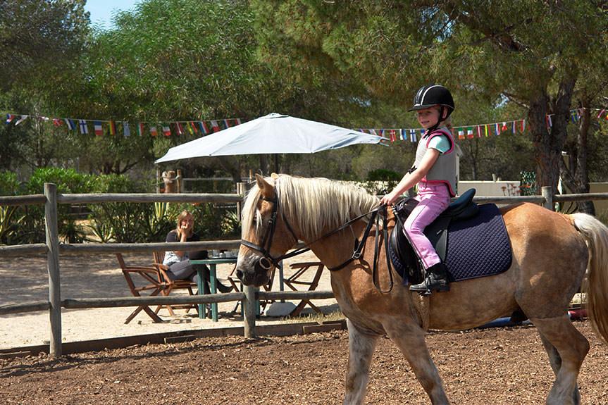 Young girl horseback riding