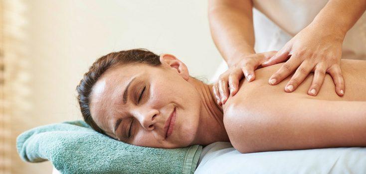 Woman receiving a back massage treatment